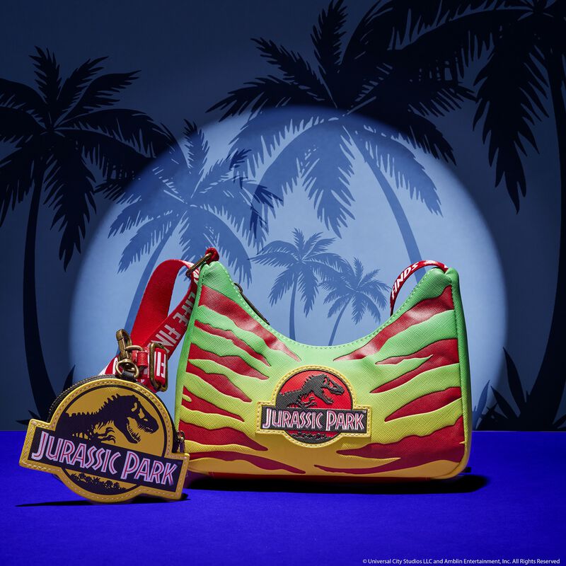 Green and yellow crossbody bag with red stripes that look like claw marks featuring the Jurassic Park logo. The strap reads "Life Finds a Way" and it comes with a Jurassic Park logo coin purse.